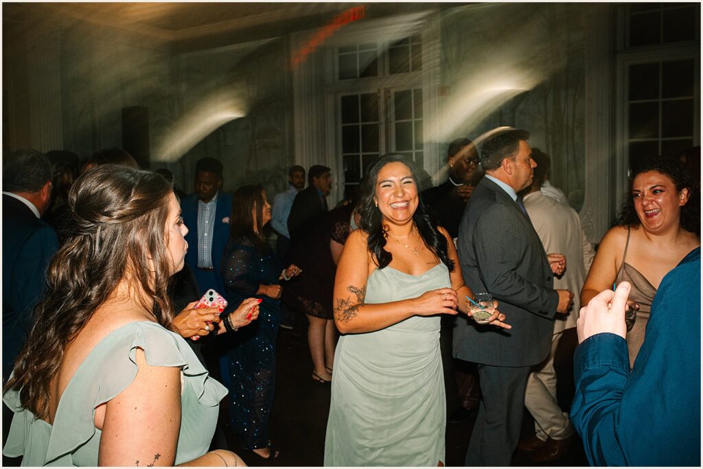 A bridesmaid smiles at a Philly wedding photographer.