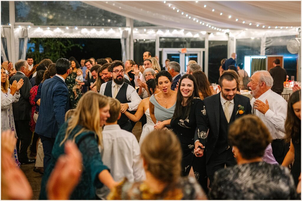 Wedding guests fill the dance floor.
