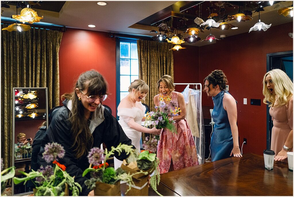 A bride and bridesmaids react to florals arriving.