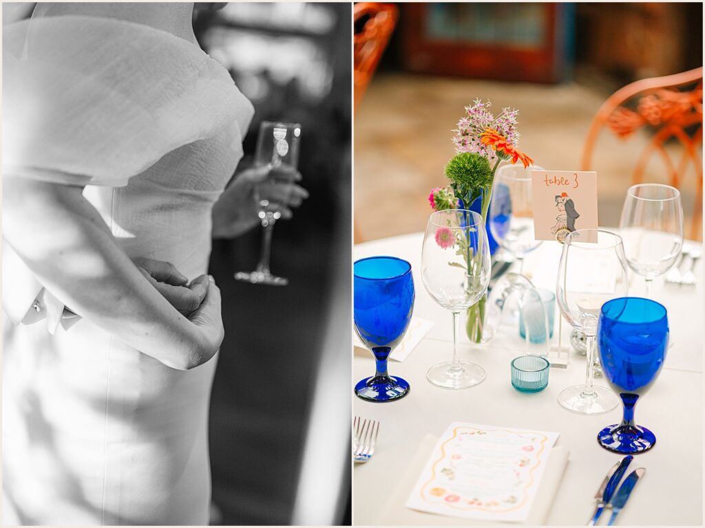 Flowers and blue glasses decorate a reception table.