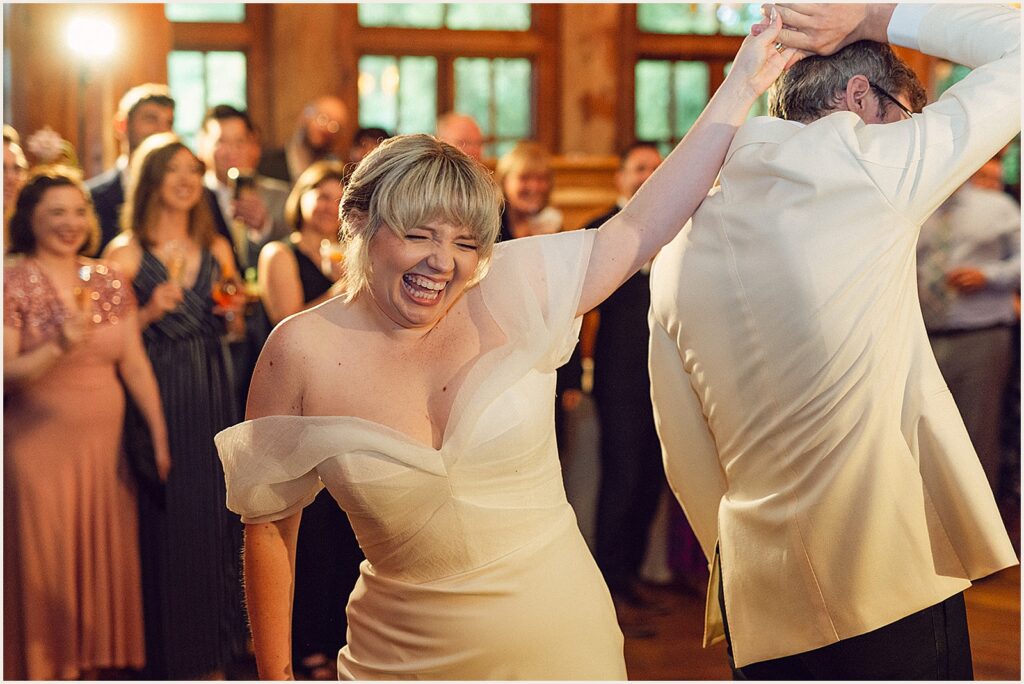 A groom twirls a bride.