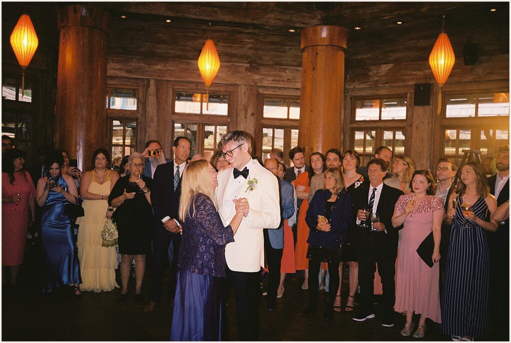 A groom dances with his mother.