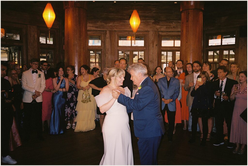 A bride dances with her father.