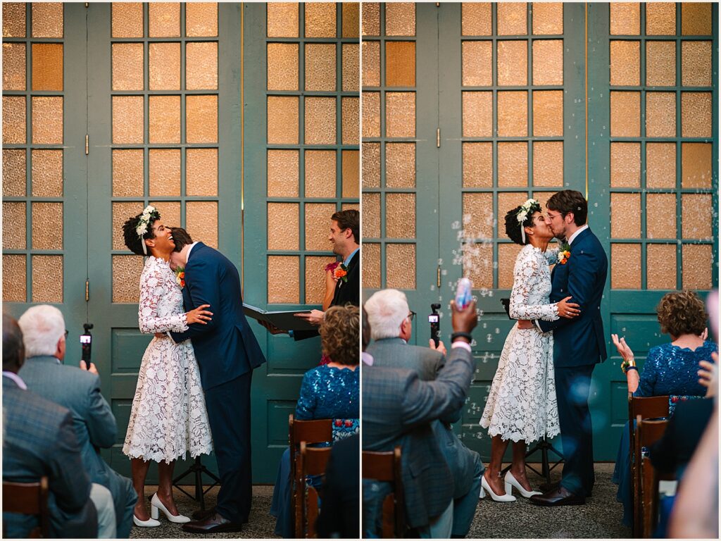 A bride and groom share their first kiss at a MAAS Building wedding.
