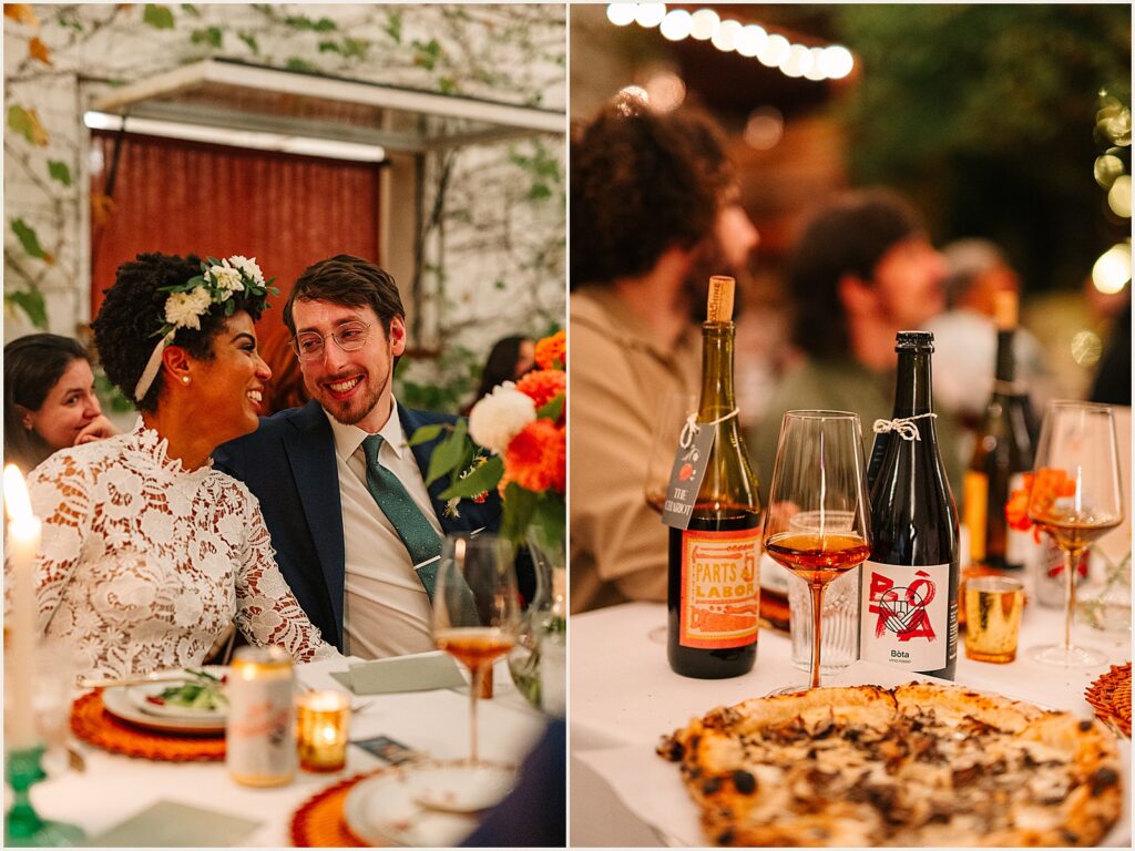 A bottle of wine sits beside a pizza on a wedding reception table.