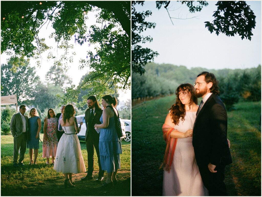 A couple stands in a patch of light at a wedding venue.
