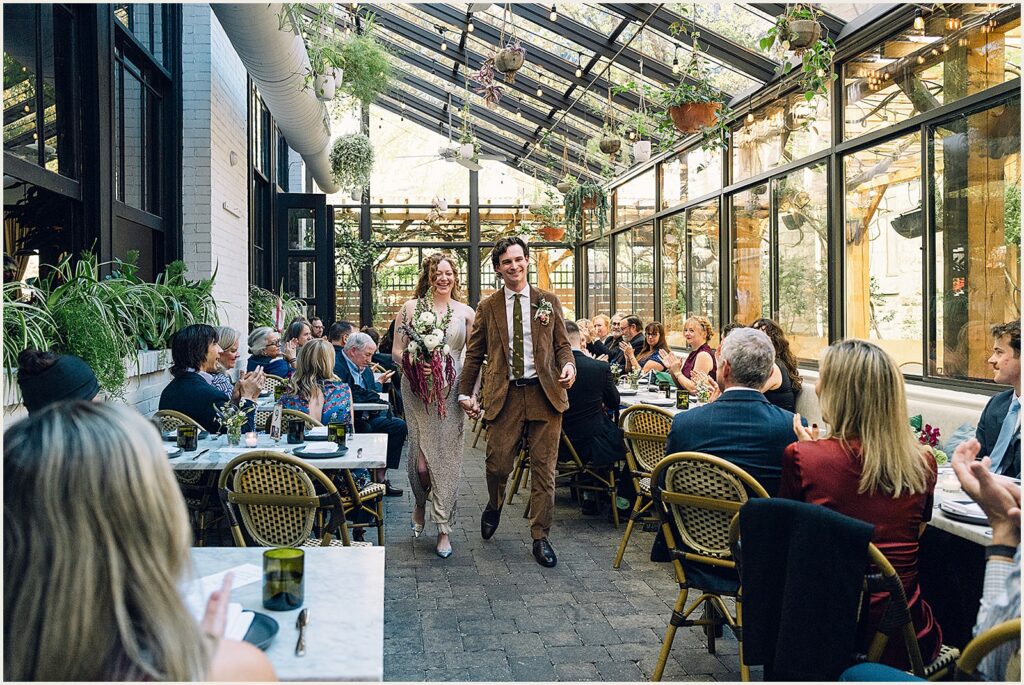 A bride and groom walk their recessional at Osteria Philadelphia.