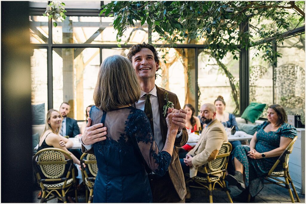A groom dances with his mother.