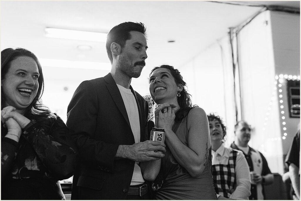 Wedding guests laugh and drink beer.