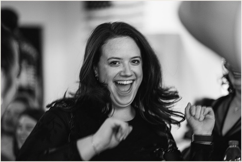 A wedding guest cheers after rolling a bowling ball.