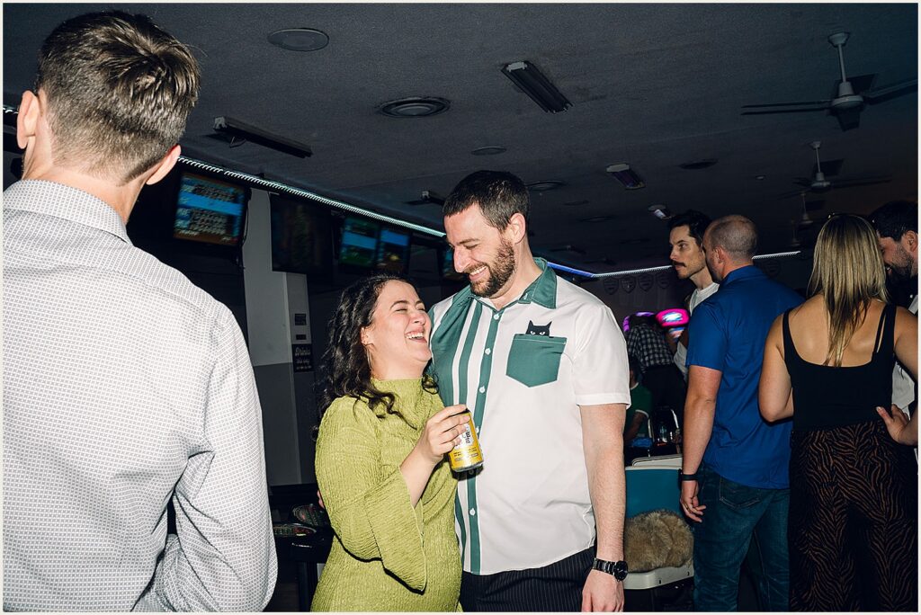Wedding guests snuggle and talk.