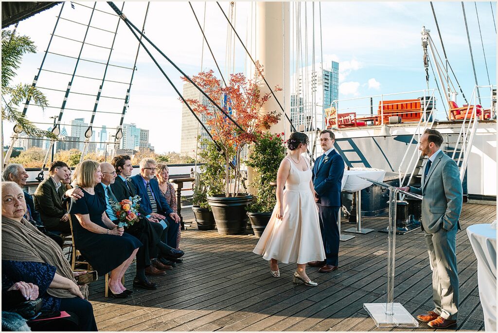 A bride walks around a groom during a ceremony aboard Moshulu Philadelphia.