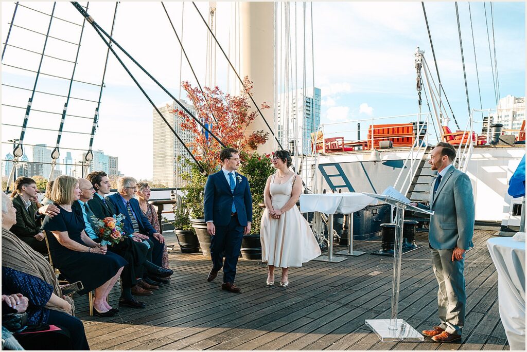A groom walks in a circle around a bride during a wedding ceremony aboard Moshulu Philadelphia.
