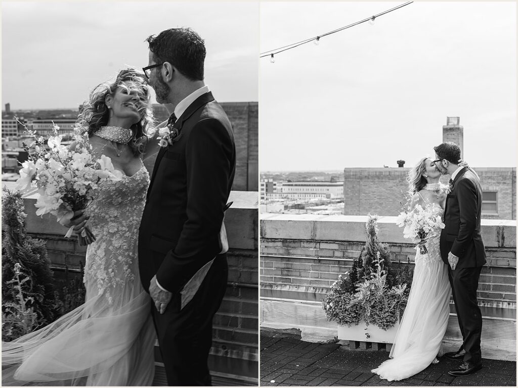 A bride and groom kiss on a rooftop wedding venue.