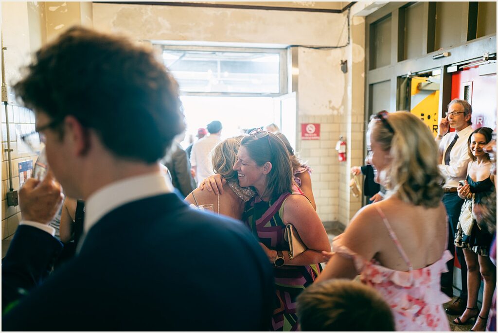 Wedding guests hug.